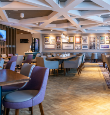 An airport lounge with a blue and neutral background