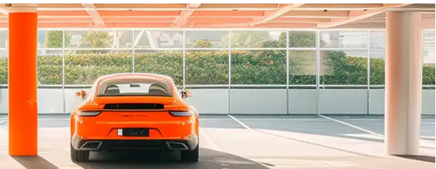 A car is parking at an Enjoy Travel parking slot
