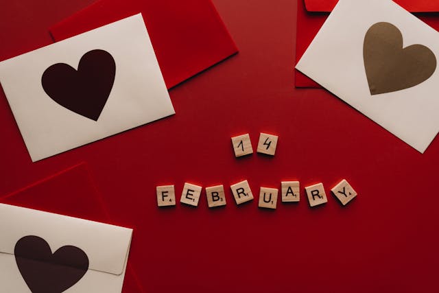 The words "14 February" surrounded by hears and red paper