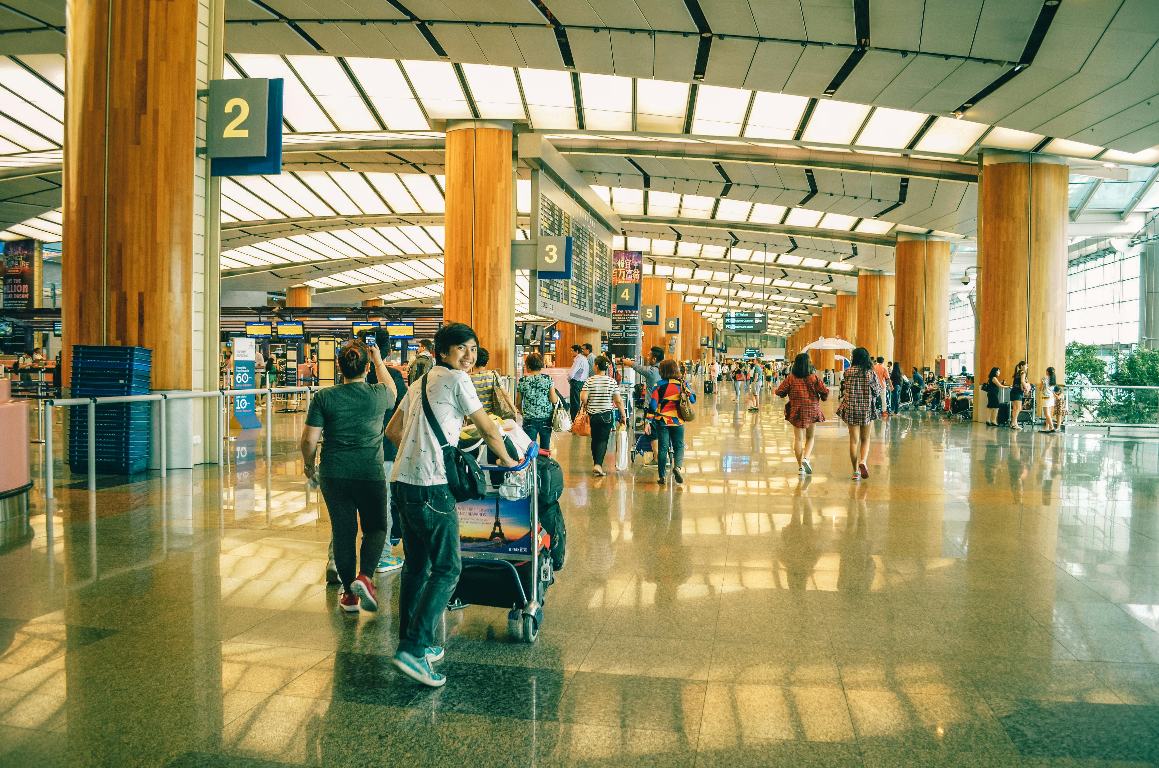 Different people with travel insurance walking in the airport