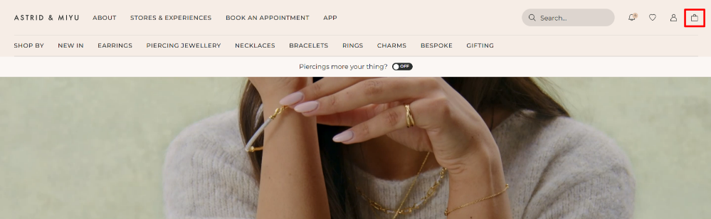 The Astrid & Miyu home page and the shopping categories and the shopping bag highlighted with a red box