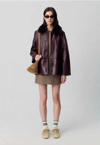 A lady that has styled the Claudie Pierlot brown leather jacket with their suede crossbody bag