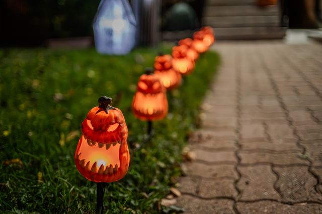 Jack-o-lanterns on someone's lawn that they saved on with a Halloween promo code