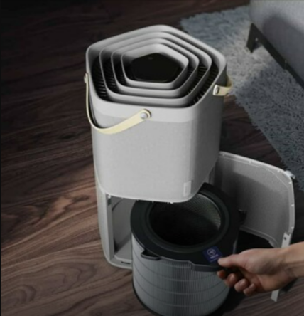 A person using the AEG portable Air Comfort Air Purifiers in a living room