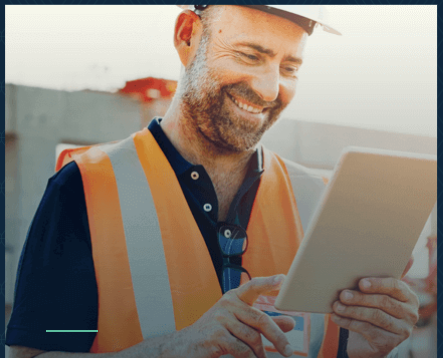 A contractor scrolling on his iPad for Kingsbridge insurance plans