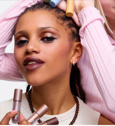 A lady posing for a portrait with her 3INA lip products