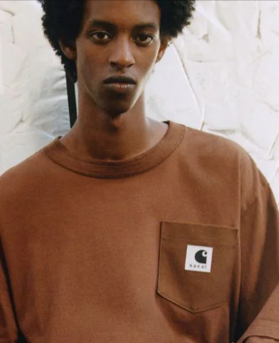 A man wearing a brown Carhatt sweater from Fat Buddha Store