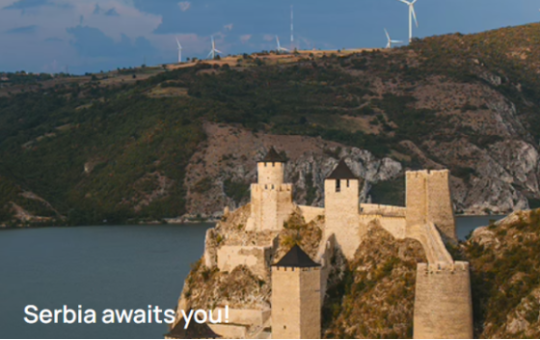 Air Serbia views with mountain, windmills, and large body of water