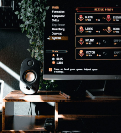 A dark-themed gaming desk setup with a monitor, speaker, and GEEKOM accessories elements for immersive experience.