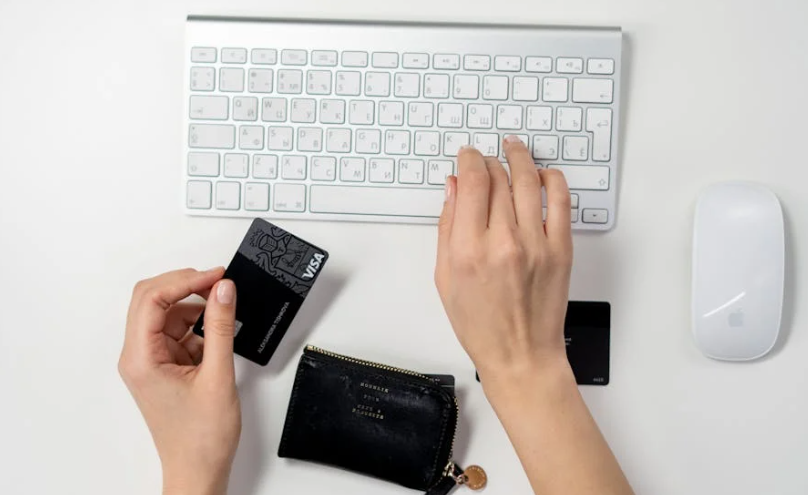 A visa debeit card with a wireless mouse and keyboard is visible on a white background