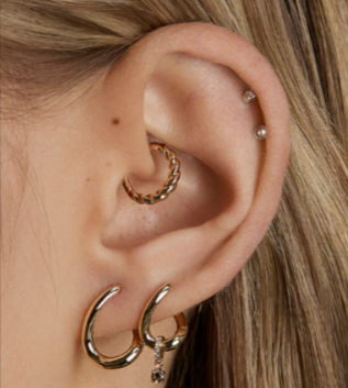 A person wearing earrings from the Astrid & Miyu stackable sets