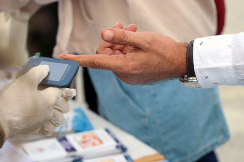 A healthcare doing one of Goodbody Clinic's tests on a patient