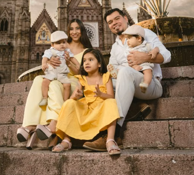 A family on a vacation in front of a church
