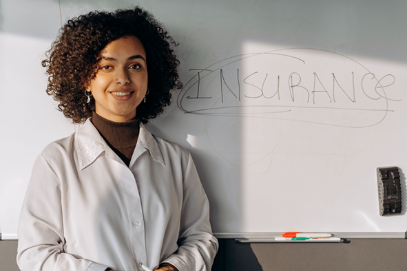 image showing a lady with a white board behind her which reads INSURANCE