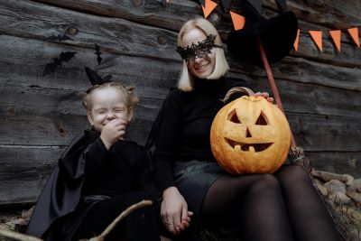 A mother and a daughter dressed in their Halloween costumes posing for a picture
