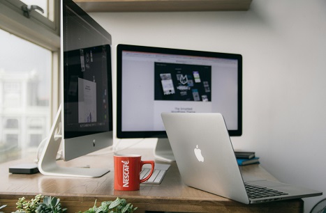 image showing computer screens and a laptop