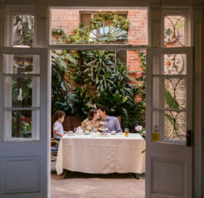 A family sitting on a patio enjoying the heating from a Castle Heaters outdoor infrared