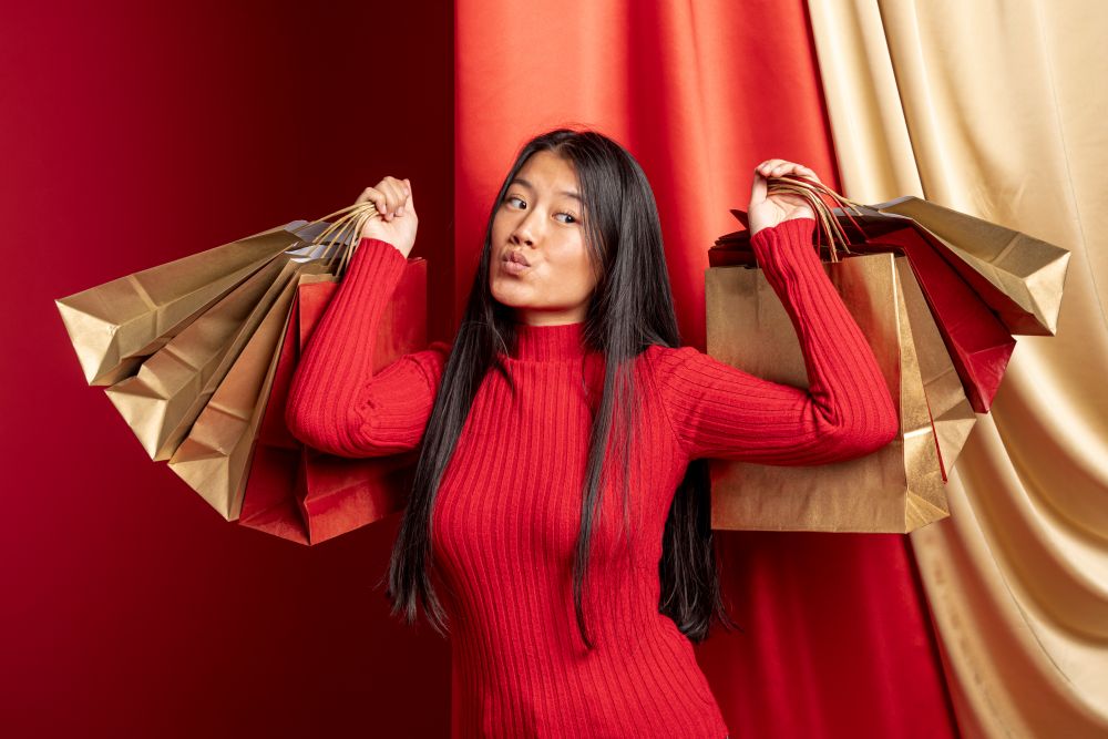 model posing with paper bags after shopping during Vogue Online Shopping Night