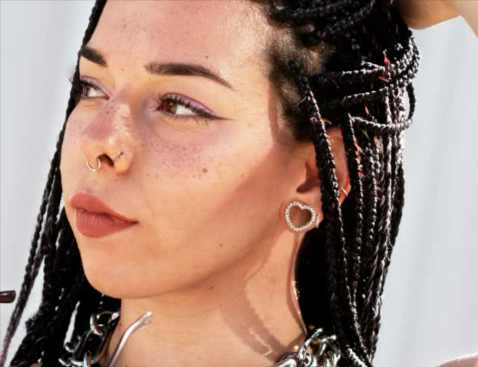 A lady posing in the sun, showing off her Crazy Factory heart-shaped tunnels