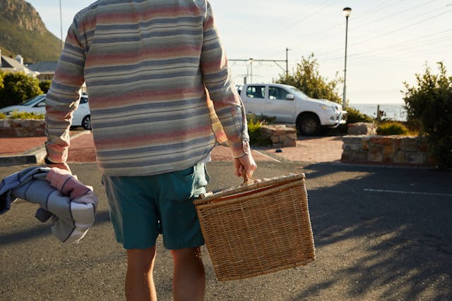 Simple Father's Day gift ideas: A man carrying a picnic basket and walking