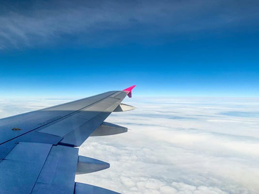 image showing an aeroplane wing in the sky