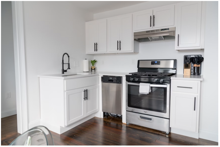 A silver stove with a hob and a silver dishwasher which you can purchase at Ship It Appliances