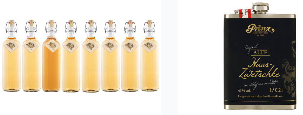 Ein Set aus mehreren vollen Alkoholflaschen neben einem Flachmann