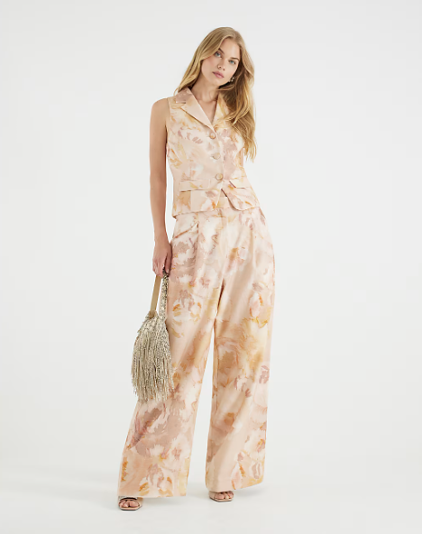 Wedding guest suits: A model wearing a floral waistcoat suit set
