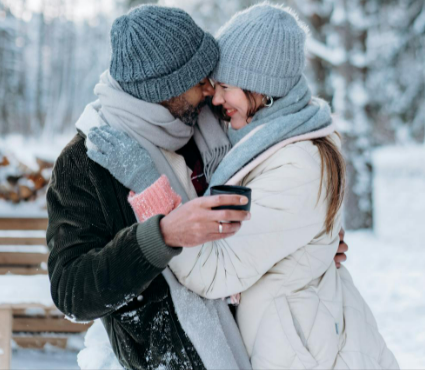 Man in grey knit cap and black jacket hugging woman in grey knit cap from Atlas For Men