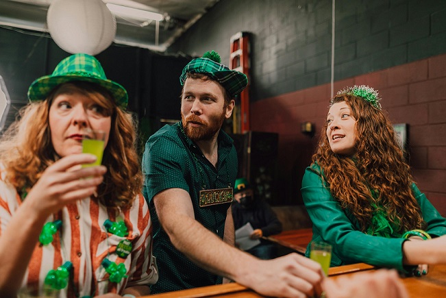 image showing three people wearing St. Patrick's Day costumes