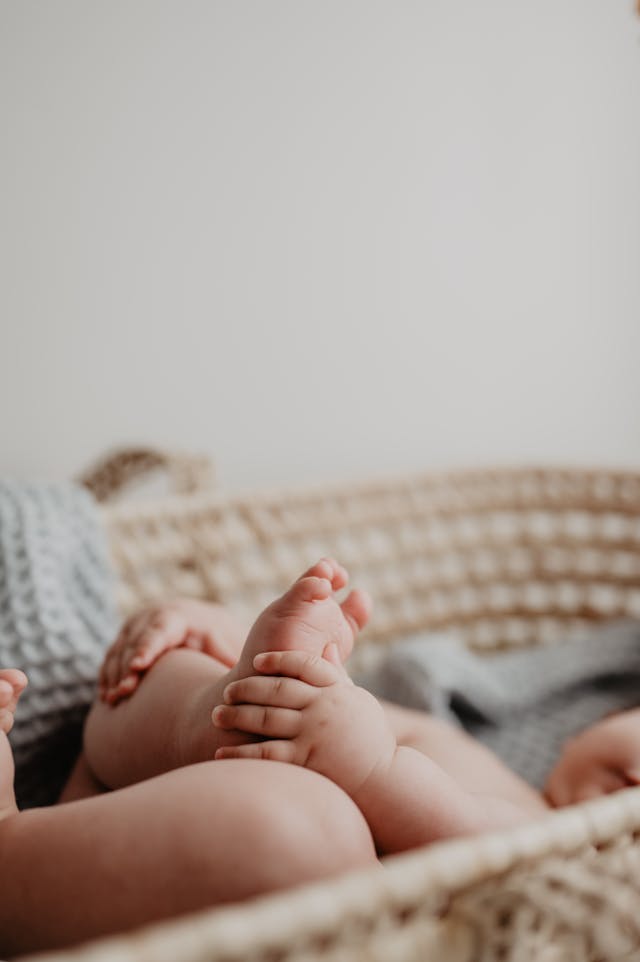 A baby laying in one of the cots from CuddleCo