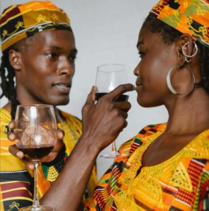 Couple-in-Traditional-Clothes-Drinking-Red-Wine-Together