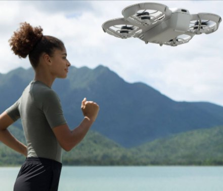 A person jogging while filming the experience with a drone