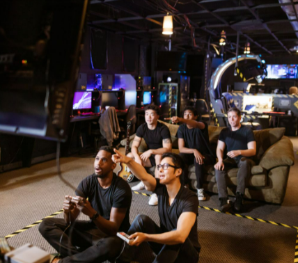 A diverse group of friends playing video games from G2A in a modern arcade setting.