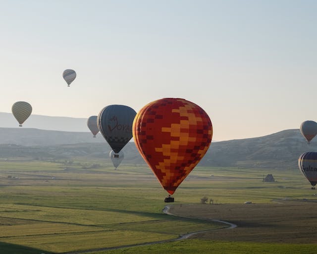 Mother's Day experience gifts: Multiple hot air balloons flying over a landscape