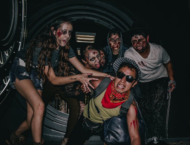 Halloween party theme ideas: A group of friends with faces painted as zombies