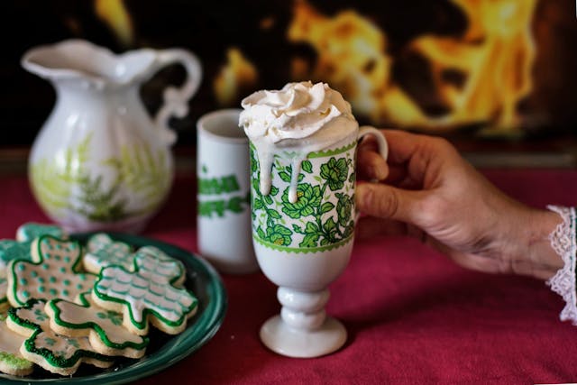 St. Patrick's Day 2026: Green and white cookies on a plate next to a mug with cream at the top