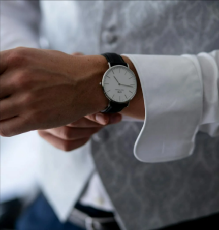 Round white and silver colored analog watch with black leather band