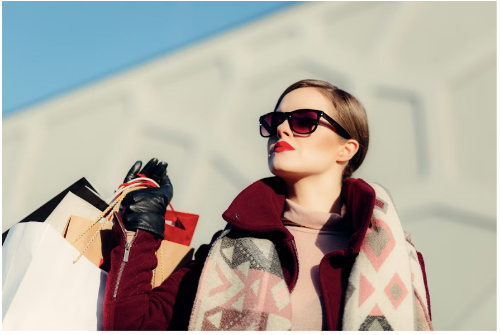 A woman carrying her shopping bags after securing all her orders