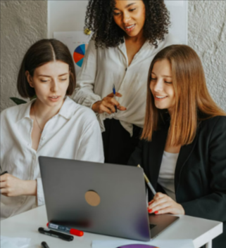 Three businesswomen work together on a laptopsaving money with free features from HostPapa.