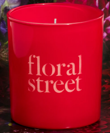 A Floral Street midnight tulip candle with a red vase