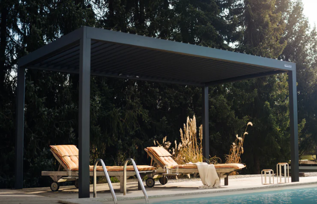 A Pergolux pergola mounted just by the poolside with pool loungers under it