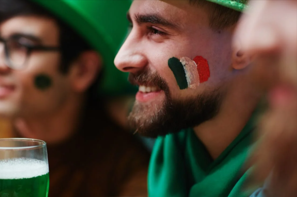 ragazzo irlandese che beve birra comprata in offerta con un codice sconto St. Patrick's Day