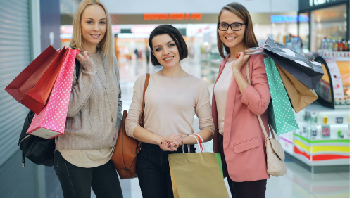 Three women, carrying their shopping bags after an International Women's Day shopping spree