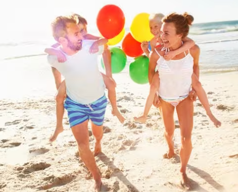 family enjoying their Emirates Skywards rewards on the beach