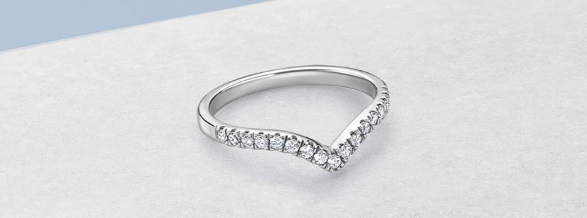 The Purely Diamonds silver diamond cut Wishbone Wedding Ring on a blue background