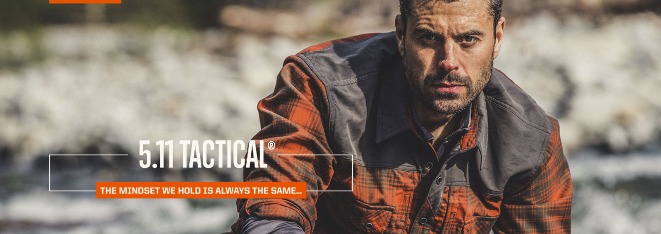 5.11 Tactical male model wearing a shirt looking straight ahead with a blurry background