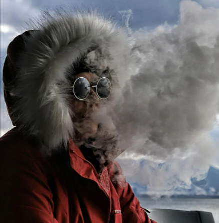 Person blowing smoke from an e-cigarette