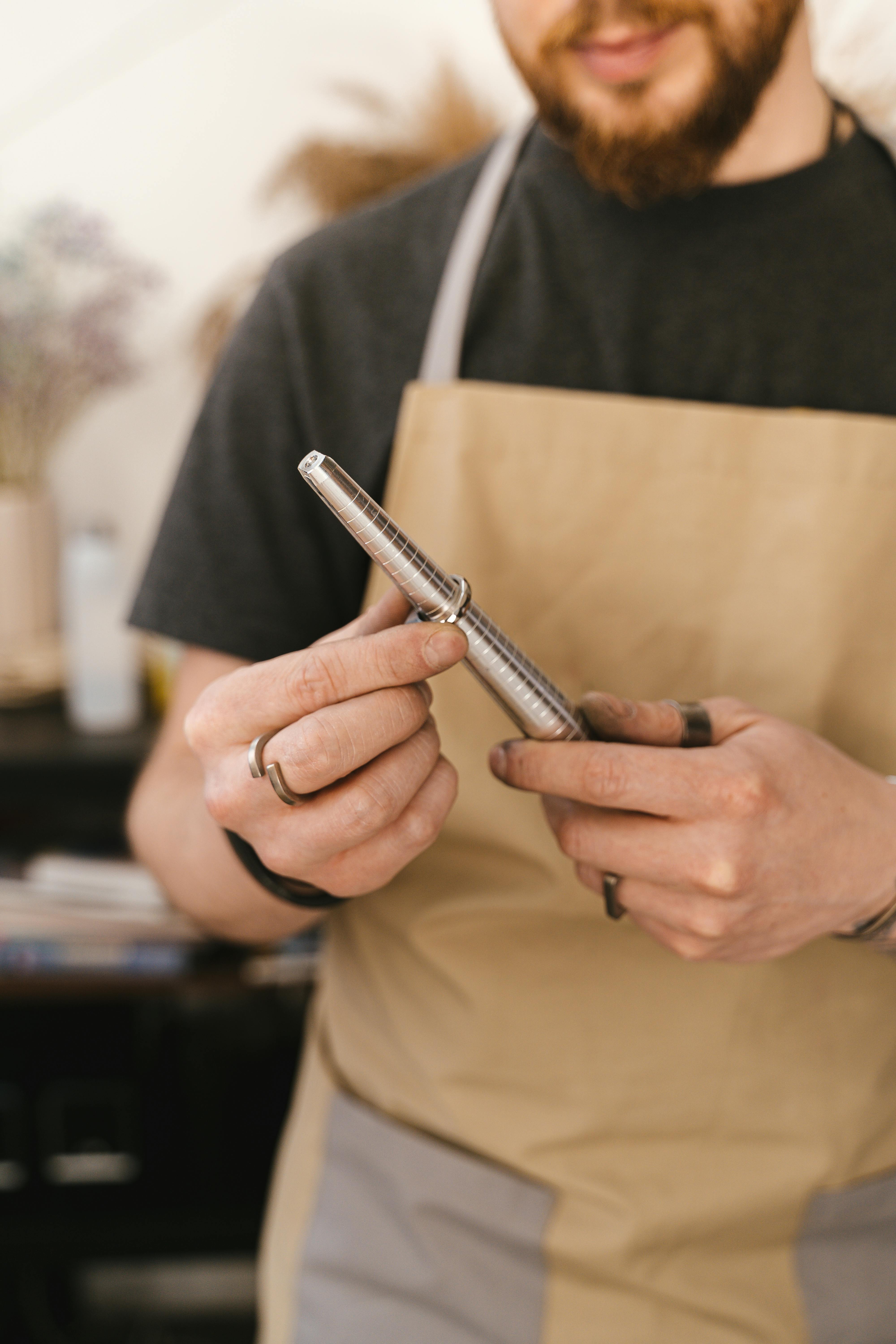 A jeweller in the workshop measuring a ring on a ring sizer.