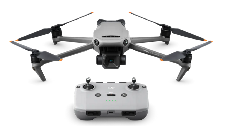 A Black, white and grey drone with four black wings at each corner all on a white background